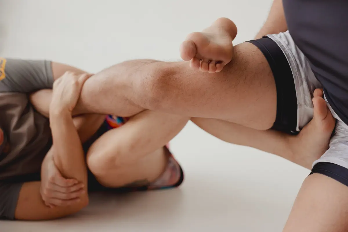 Close-up of two students working a No-Gi leg entanglement.